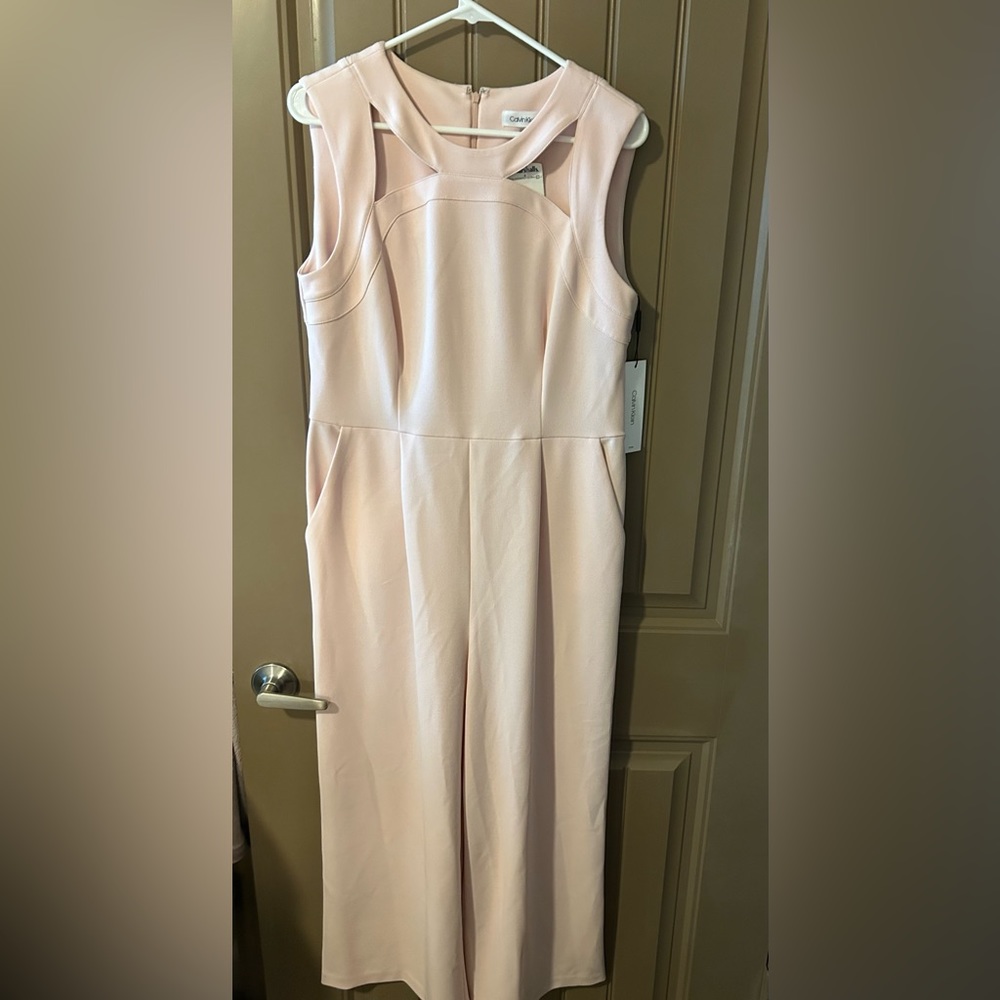 Calvin Klein NWT light peach jumpsuit! Size 12. Sleeveless with detail at neck.